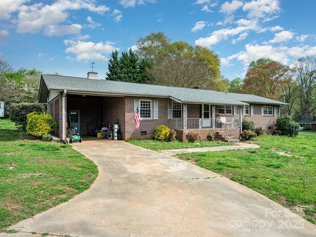 single story home with a carport, covered porch, and a front yard