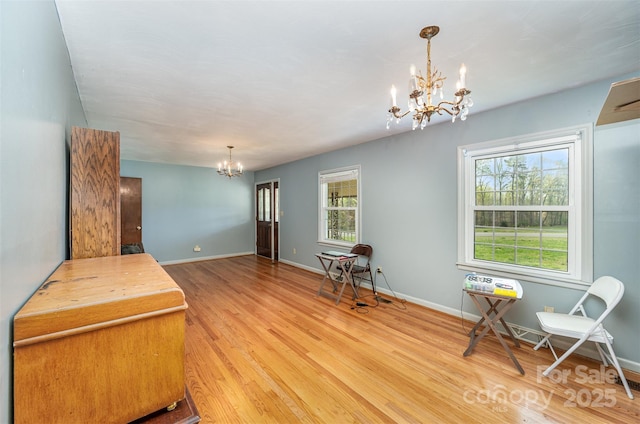 sitting room with a notable chandelier, light hardwood / wood-style floors, and plenty of natural light