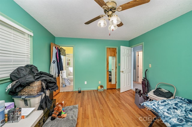 interior space with ceiling fan, light hardwood / wood-style floors, and a textured ceiling