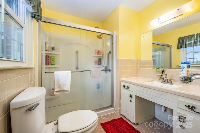 bathroom with walk in shower, tile patterned flooring, tile walls, and toilet