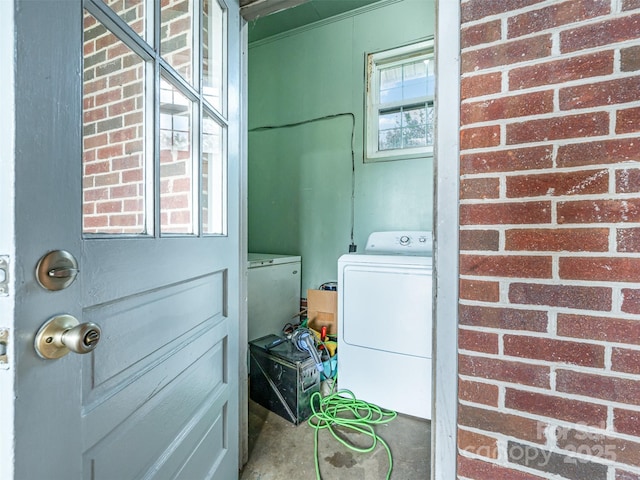 clothes washing area featuring washer and clothes dryer