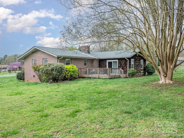 back of property featuring a deck and a yard