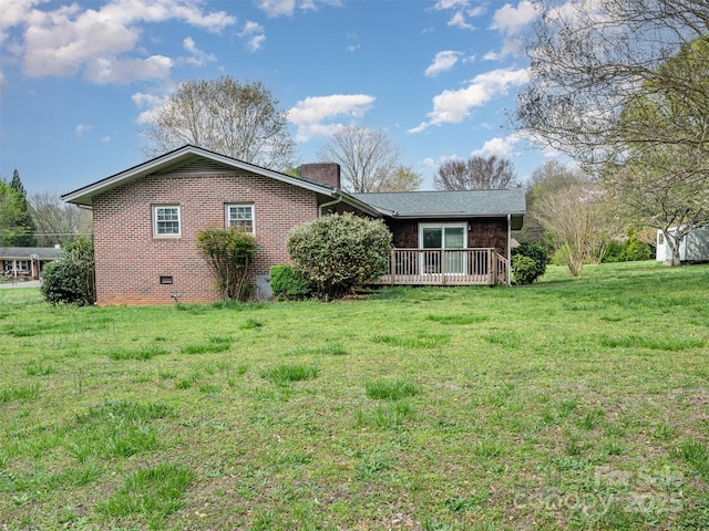 view of front facade with a deck and a front lawn