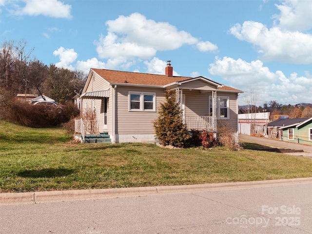 bungalow-style house featuring a front lawn