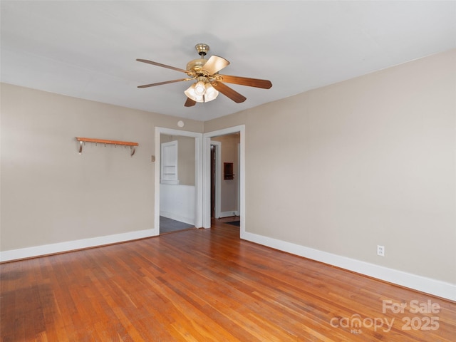 unfurnished room featuring hardwood / wood-style floors and ceiling fan