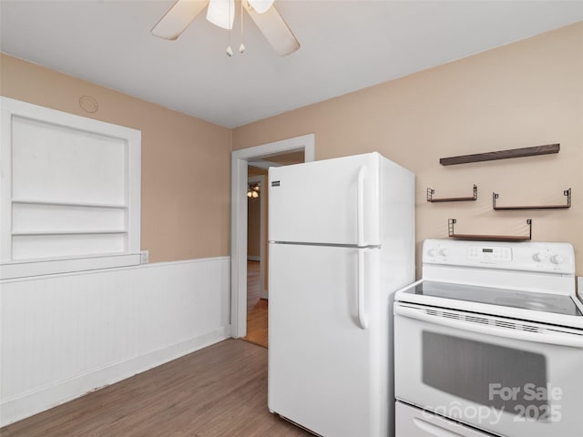 kitchen featuring hardwood / wood-style floors, ceiling fan, and white appliances