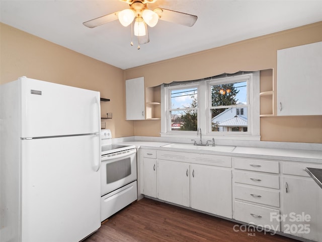 kitchen with white cabinets, white appliances, dark wood-type flooring, and sink