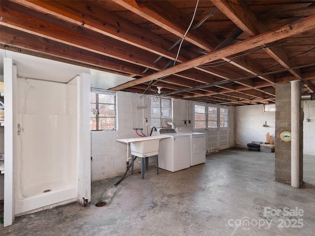 basement featuring washer and clothes dryer and sink