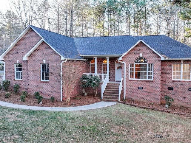 ranch-style house featuring a front lawn and covered porch