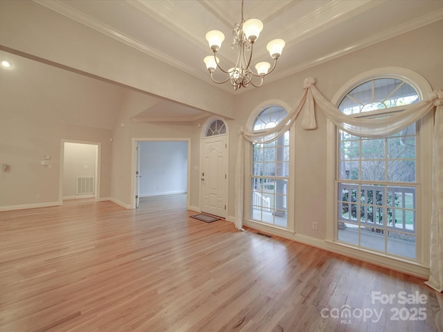 unfurnished dining area featuring a notable chandelier, light hardwood / wood-style floors, and ornamental molding