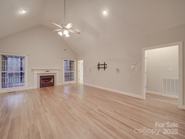 unfurnished living room featuring ceiling fan, light hardwood / wood-style floors, and high vaulted ceiling