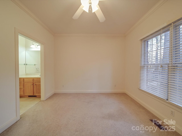 carpeted spare room with ceiling fan and ornamental molding