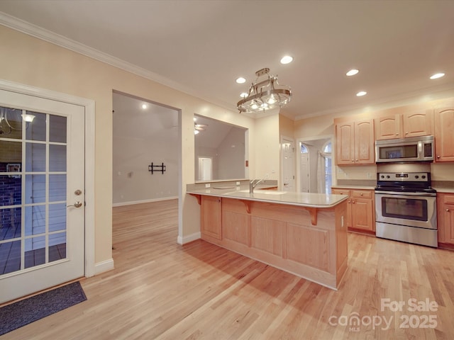 kitchen featuring kitchen peninsula, appliances with stainless steel finishes, crown molding, and light brown cabinetry