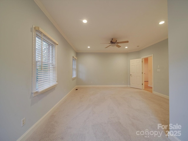 carpeted empty room with ceiling fan and ornamental molding