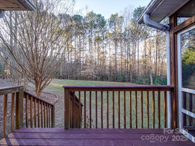 wooden deck featuring a yard