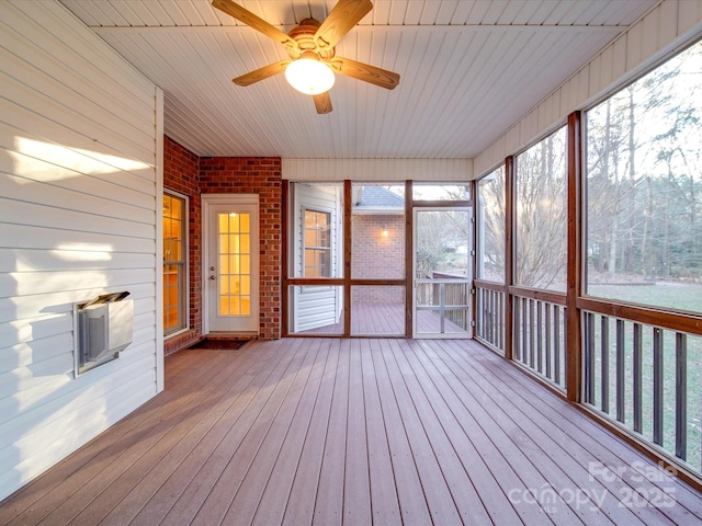 unfurnished sunroom with ceiling fan and wood ceiling