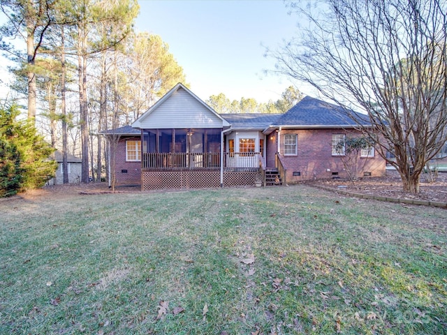 back of house with a lawn and a sunroom