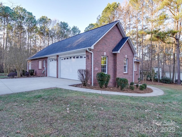 view of side of property with a yard and a garage