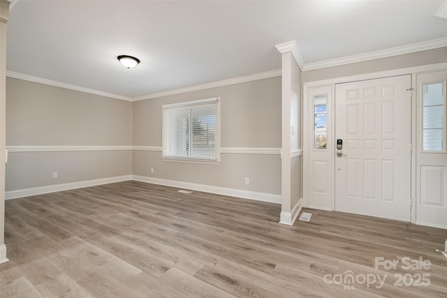 entryway featuring wood-type flooring and ornamental molding