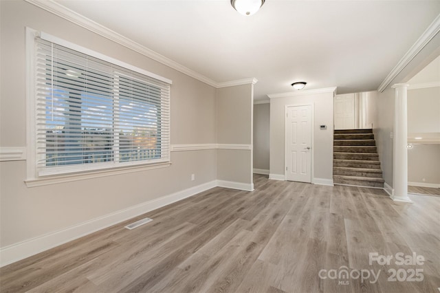 unfurnished living room with light wood-type flooring and ornamental molding