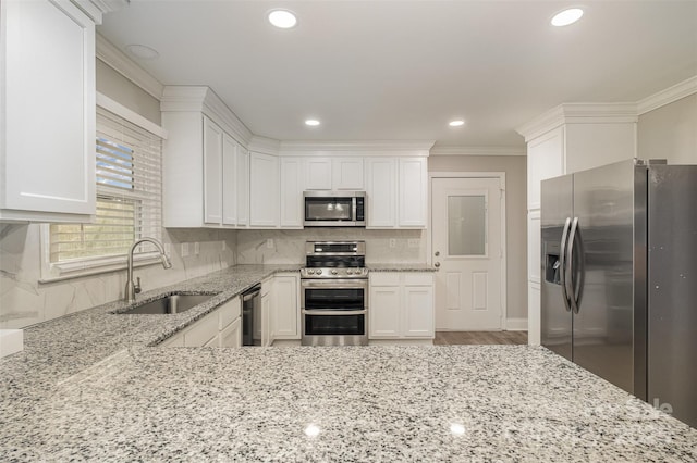 kitchen featuring white cabinets, light stone counters, sink, and stainless steel appliances