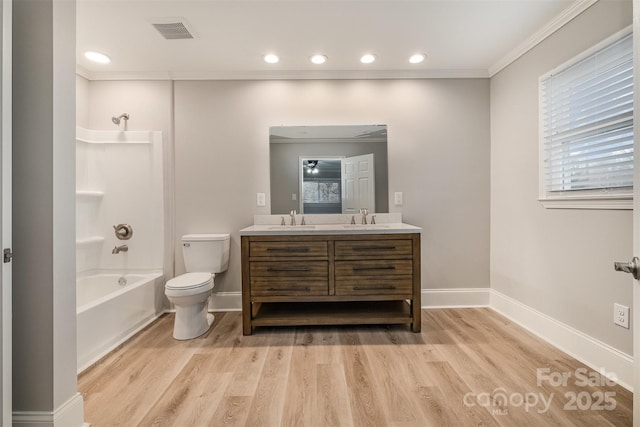 full bathroom featuring tub / shower combination, vanity, crown molding, hardwood / wood-style floors, and toilet