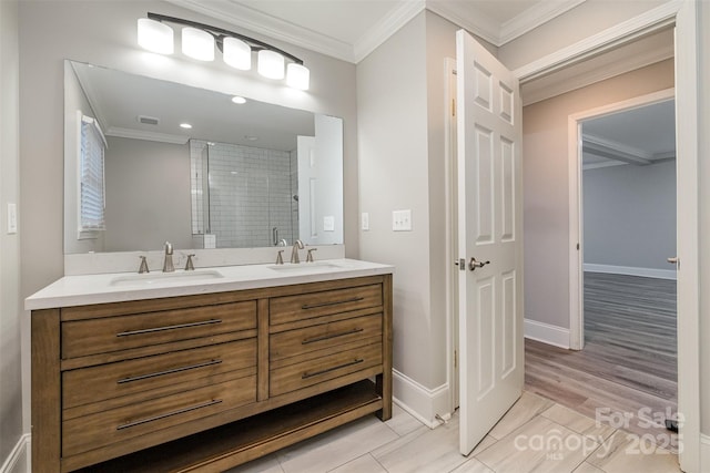 bathroom featuring hardwood / wood-style floors, vanity, a shower with door, and crown molding