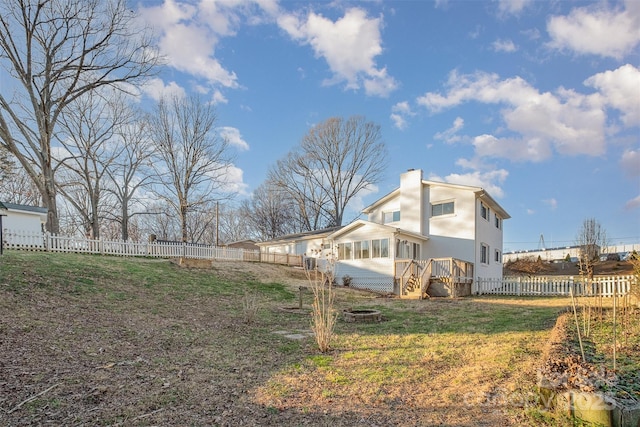 view of side of home featuring an outdoor fire pit