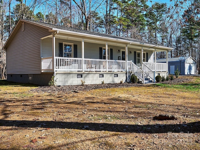 view of front facade featuring covered porch and an outdoor structure