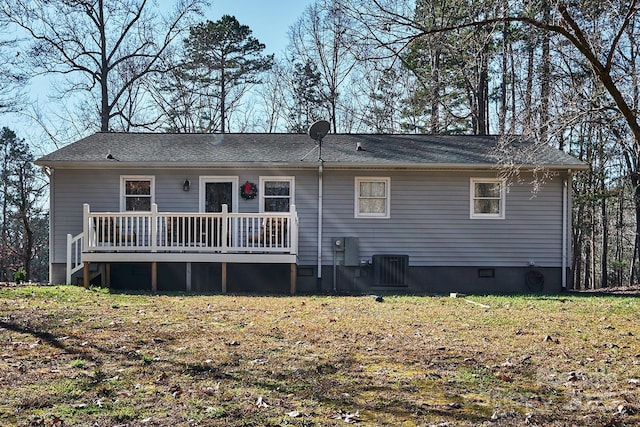 back of property featuring central air condition unit, a yard, and a deck