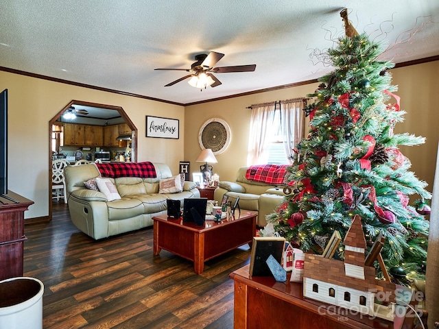 living room featuring dark hardwood / wood-style floors, ceiling fan, crown molding, and a textured ceiling