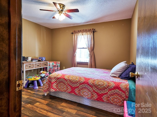 bedroom featuring ceiling fan, dark wood-type flooring, and a textured ceiling