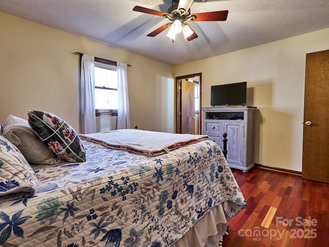 bedroom with a textured ceiling, dark hardwood / wood-style floors, and ceiling fan