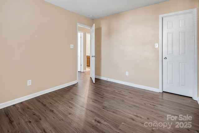 spare room with hardwood / wood-style floors