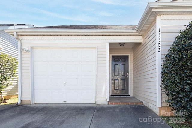 doorway to property with a garage