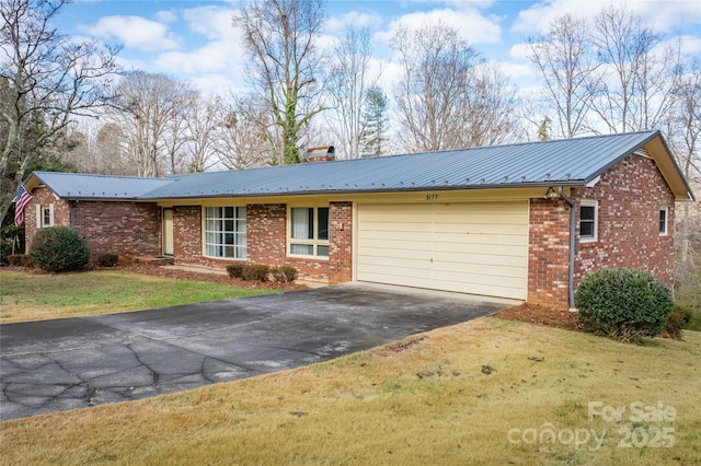 single story home featuring a garage and a front lawn