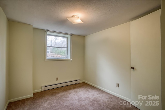 carpeted spare room featuring baseboard heating and a textured ceiling