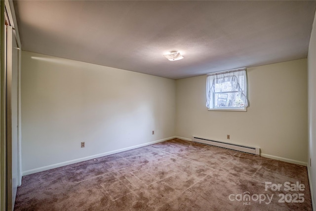 carpeted spare room featuring baseboard heating