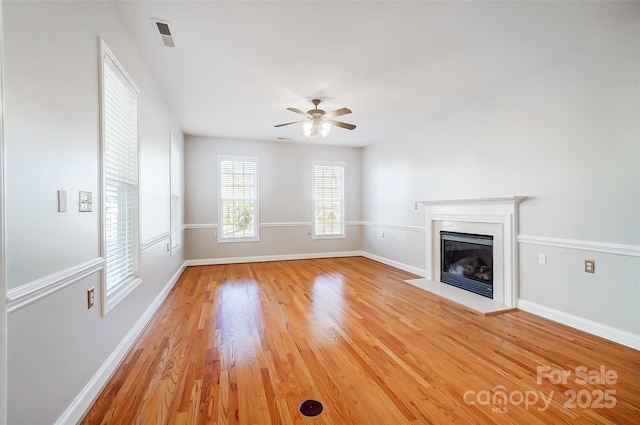 unfurnished living room with ceiling fan and light hardwood / wood-style flooring