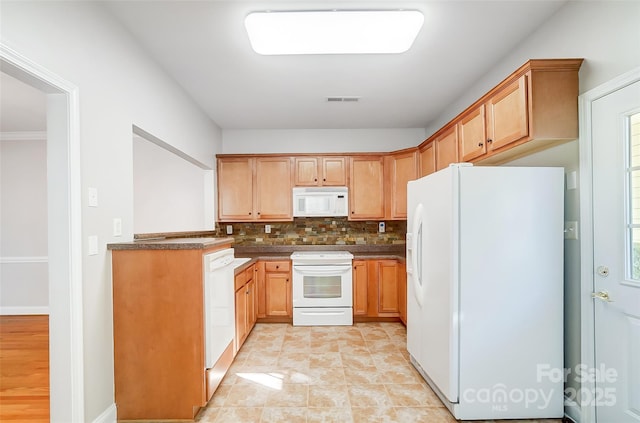 kitchen featuring decorative backsplash and white appliances