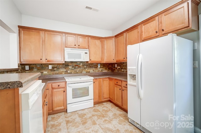 kitchen with decorative backsplash and white appliances