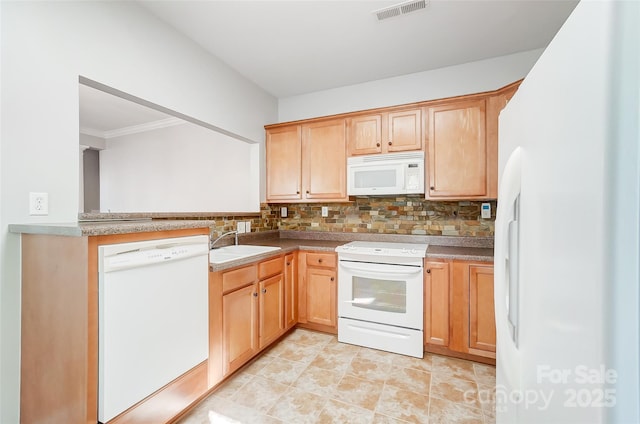 kitchen with sink, white appliances, and backsplash