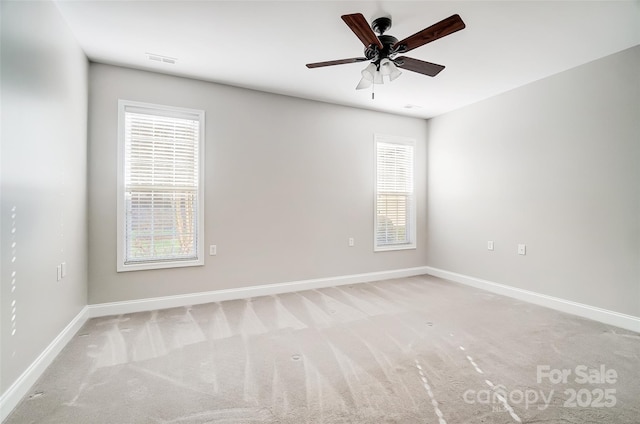 empty room with light colored carpet and ceiling fan