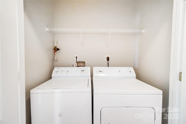 clothes washing area with washing machine and clothes dryer