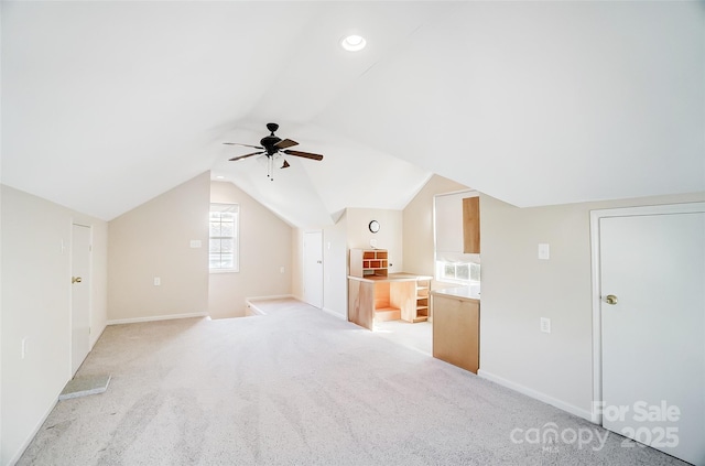 bonus room featuring light colored carpet, ceiling fan, and lofted ceiling