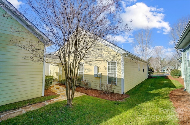 view of side of property with a yard