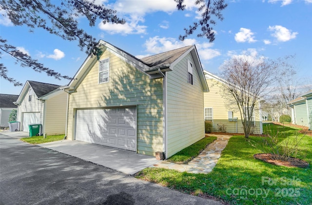 view of property exterior featuring a yard and a garage