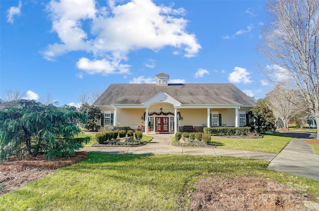 view of front of home with covered porch and a front yard