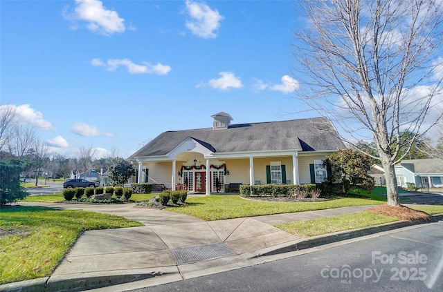 view of front of house with a porch and a front yard