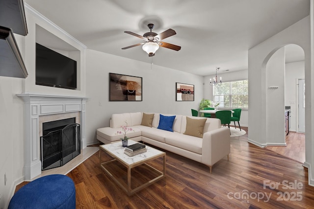 living room featuring dark hardwood / wood-style floors and ceiling fan with notable chandelier